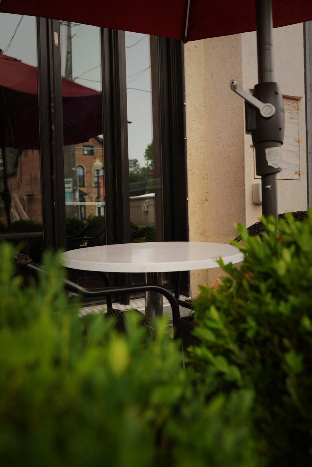Patio table under a red umbrella at AGI