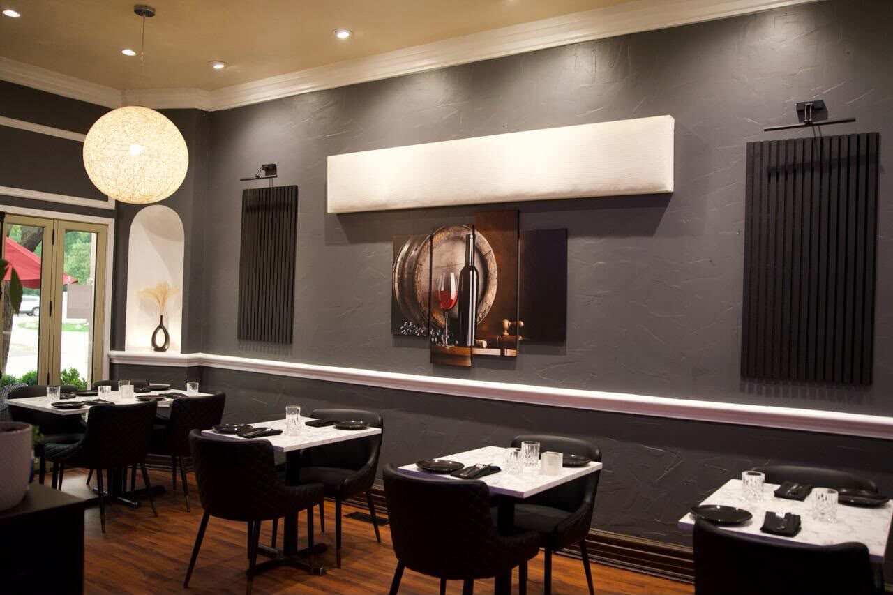 The AGI dining room — marble tables and dark walls